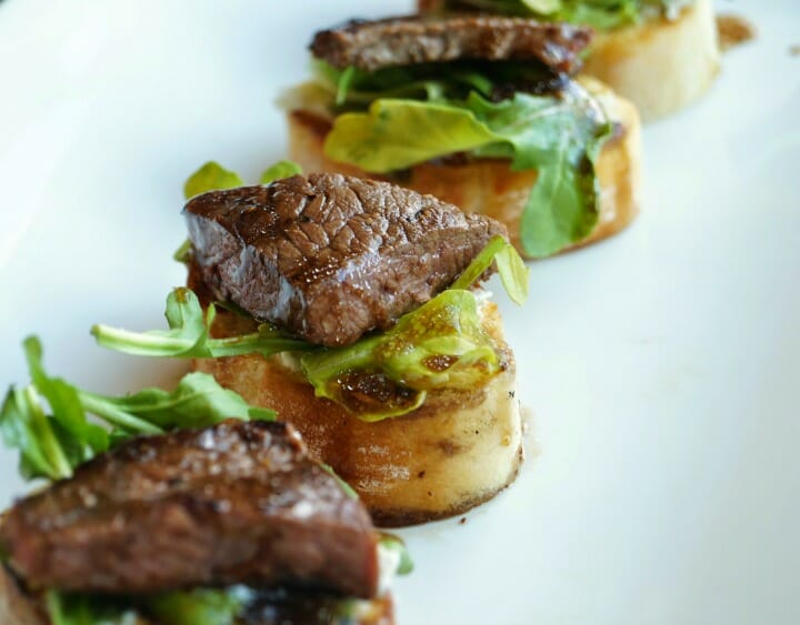 Balsamic Beef Crostini with Herbed Cheese and Arugula 